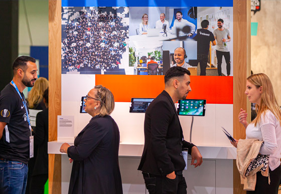 Indeed representatives interactiving with attendees at a tradeshow