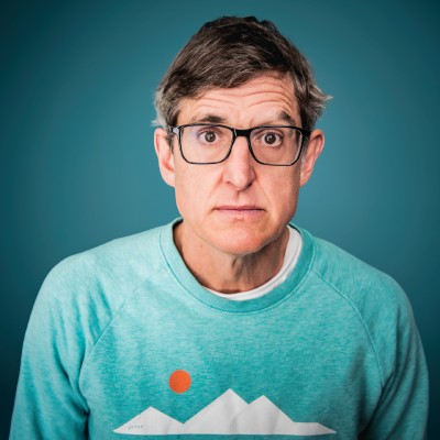 Headshot photo of Louis Theroux looking at the camera