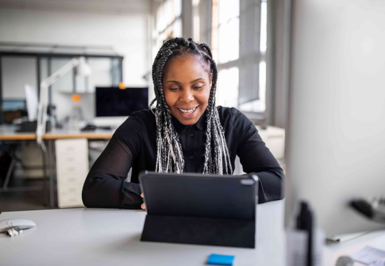 Smiling woman in front of her laptop
