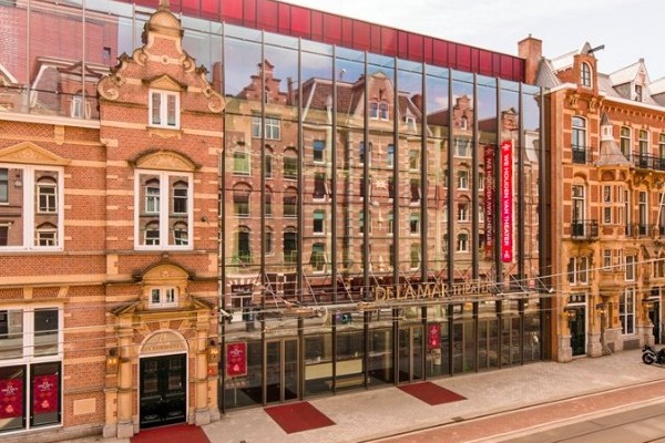 A picture of the DeLaMar Theatre with reflections shining off the glass on the front of the building