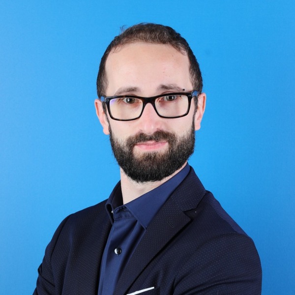 Headshot photo of Gianluca Bonacchi looking at the camera