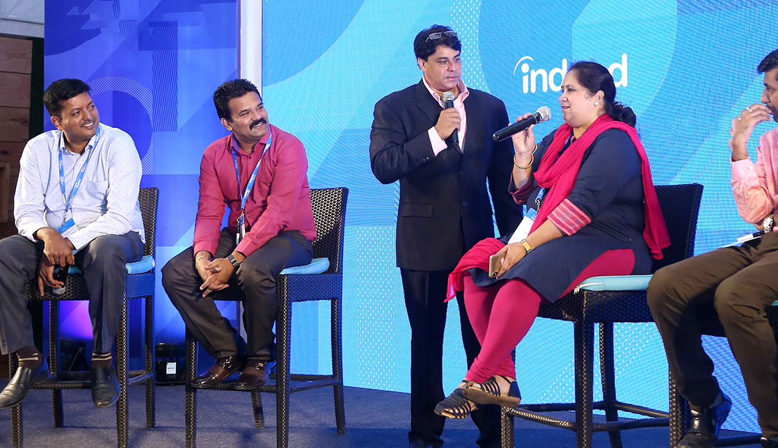 Panelists on stage at an Indeed event
