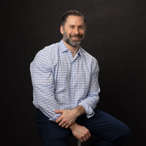 Headshot photo of Tony Nelan looking at the camera