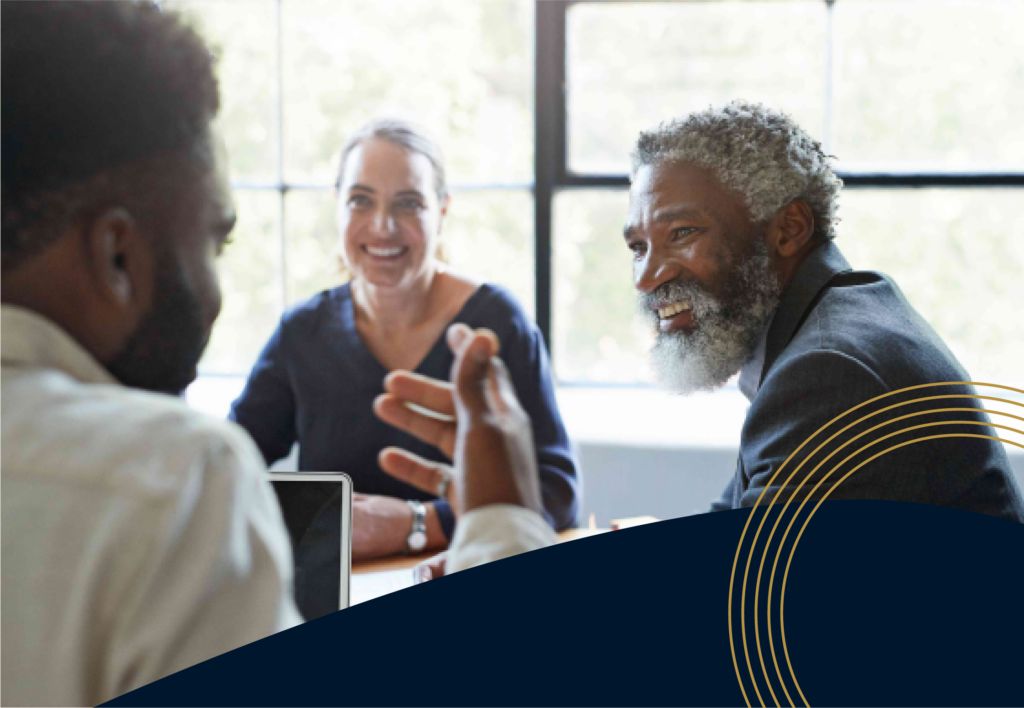 Leaders discussing and smiling around a conference table