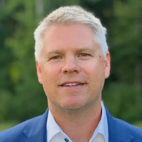 Headshot photo of Chris Glynn looking at the camera